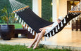 bLifestyle shot of hammock in a covered terrace surrounded by minimalist decor