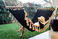 Lifestyle shot of hammock in a covered terrace, surrounded by minimalist decor