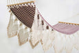 Handwoven pomegranate hammock with teak bar and fringe