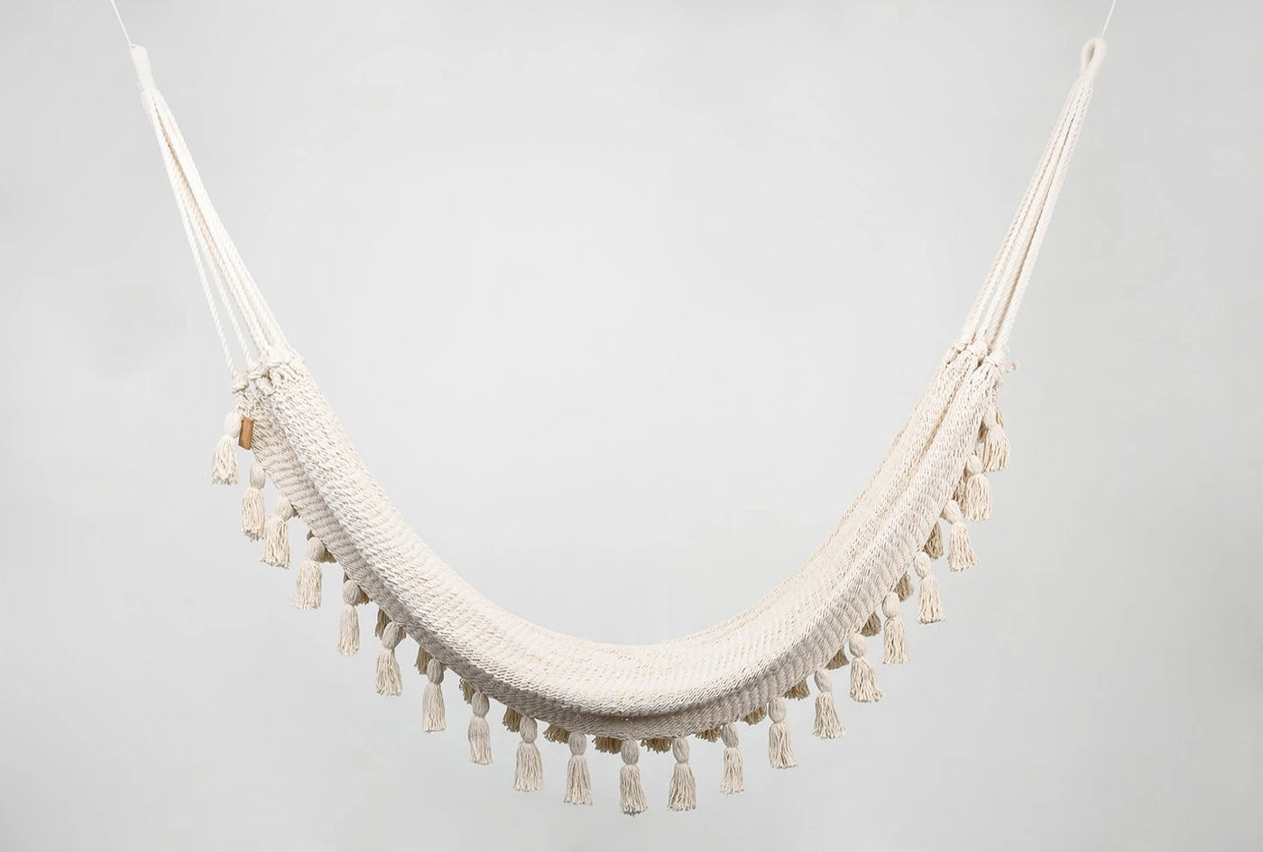 Handwoven natural cotton hammock with hand-tied tassels