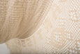Detail view of natural cotton weave and fringe on a handmade hammock
