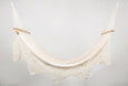Handwoven natural cotton hammock in natural color with solid teak bar and geometric fringe