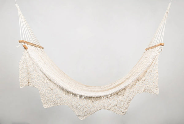 Handwoven natural cotton hammock in natural color with solid teak bar and geometric fringe