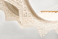 Cotton hammock in natural color featuring hand-tied tassels and elegant drape