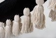 Close-up of artisan knotting and tassel detailing on the Boho Noir cotton hammock