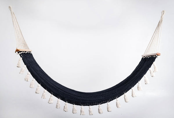 Handwoven black cotton hammock with solid teak bar and hand-tied tassels