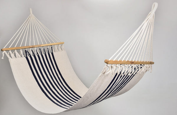 Handwoven triple weave hammock in navy and natural cotton with wooden spreader bar, showcasing colonial-inspired design and artisan craftsmanship.