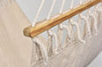 Close-up of natural wooden bar and triple-strand cotton weave, highlighting handmade detailing.