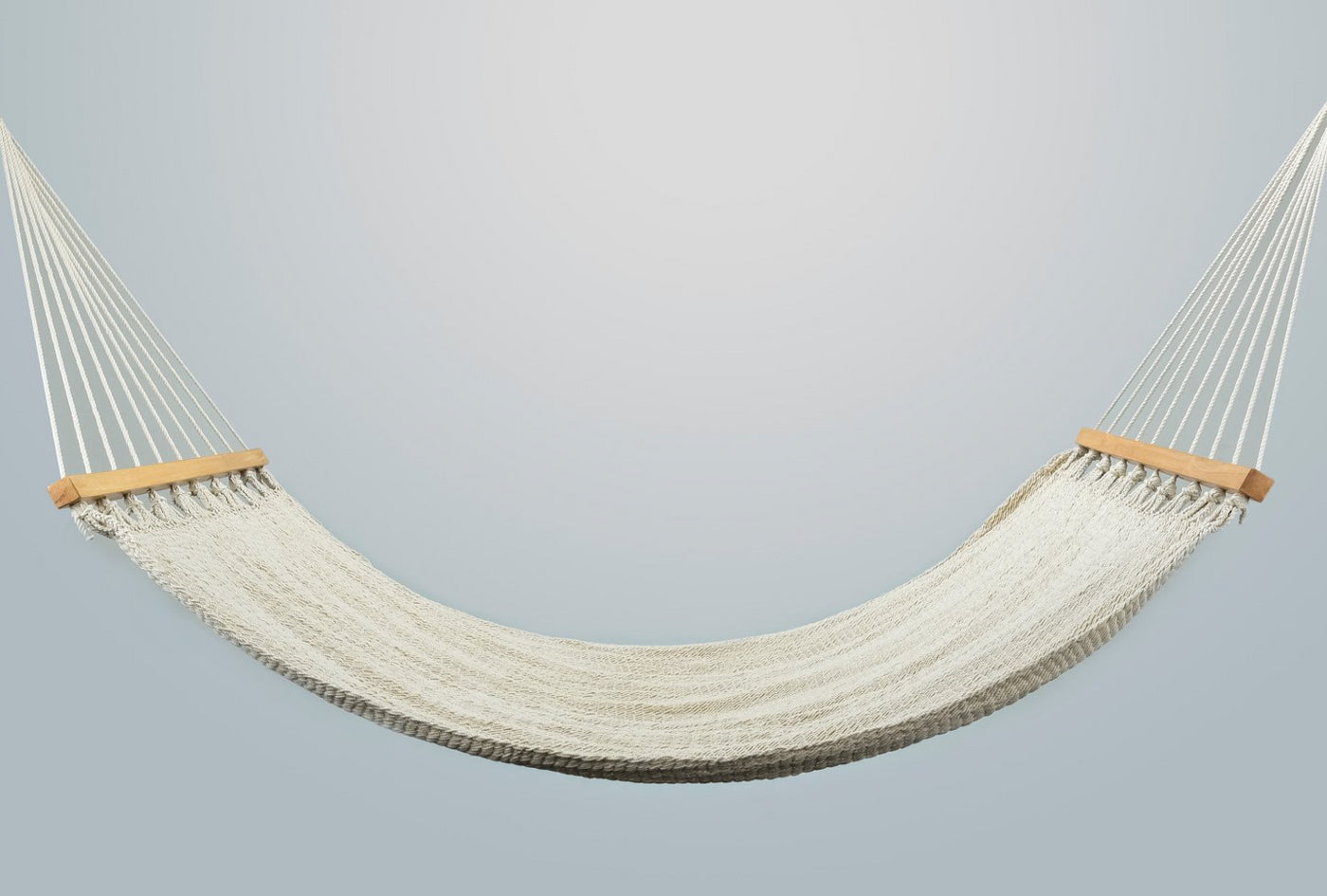 Handwoven cotton hammock with teak wood spreader bar in earth tones
