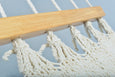 Artisan-crafted cotton hammock with teak wood detailing