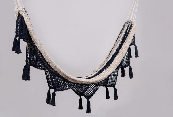Handwoven colonial navy cotton hammock with elegant hand-tied tassels draped indoors