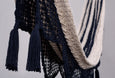 Close-up of hand-tied tassels on a navy cotton hammock with natural drape design
